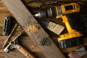 Outils de construction sur établi – perceuse, pince, pinceau, vis et marteau - construction HERA